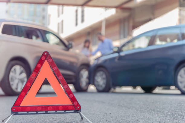 Red emergency triangle on the road indicates